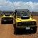 2 Land Rovers driving through a rocky desert